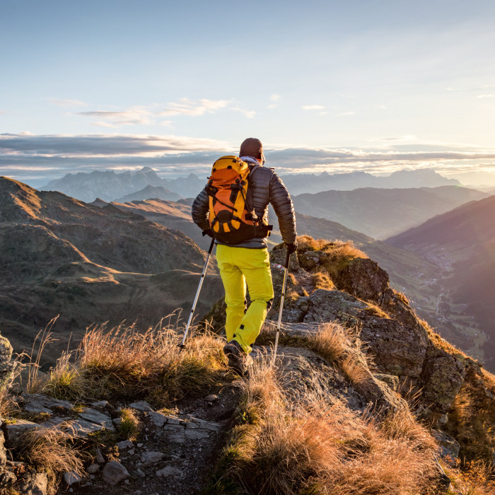 Mountaineer hiking in the mountains in morning light
